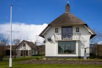 white concrete house on green grass field during daytime